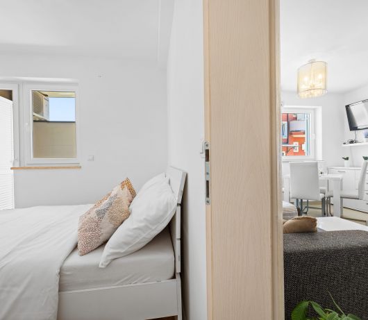 Charming White Apartment with Balcony and Parking